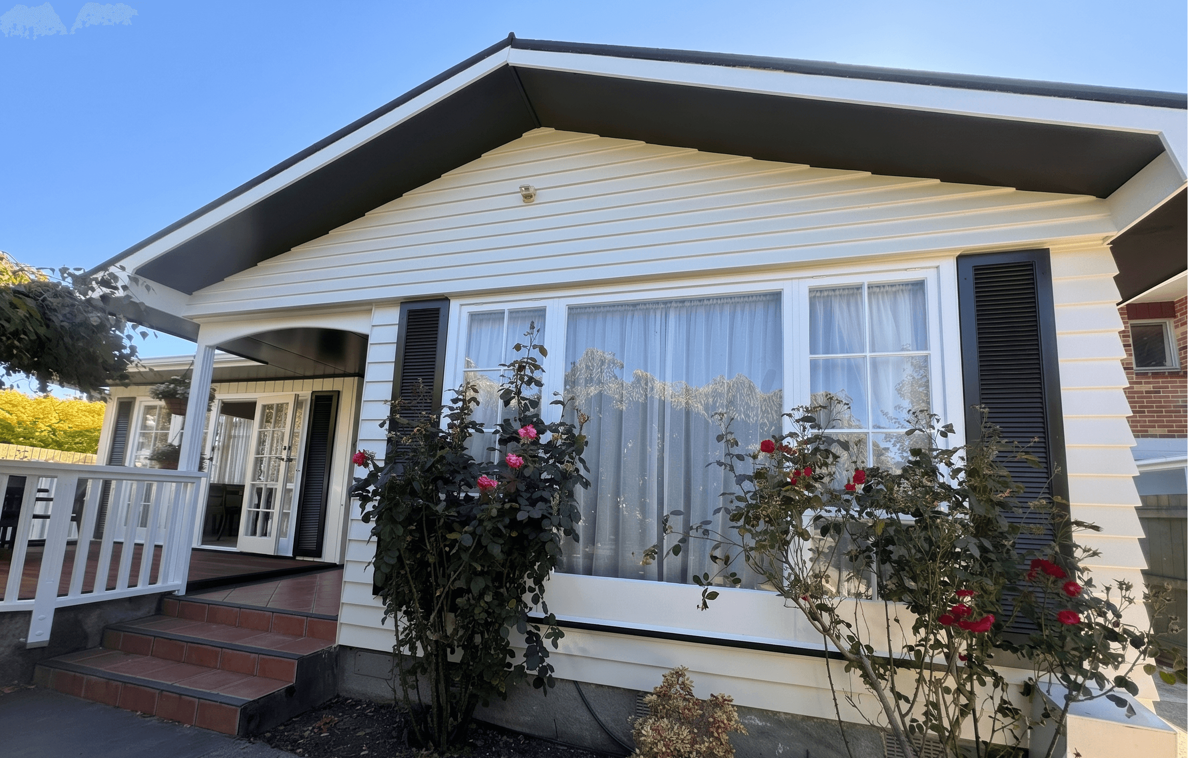 A freshly painted weatherboard home by Two Brothers Decorators